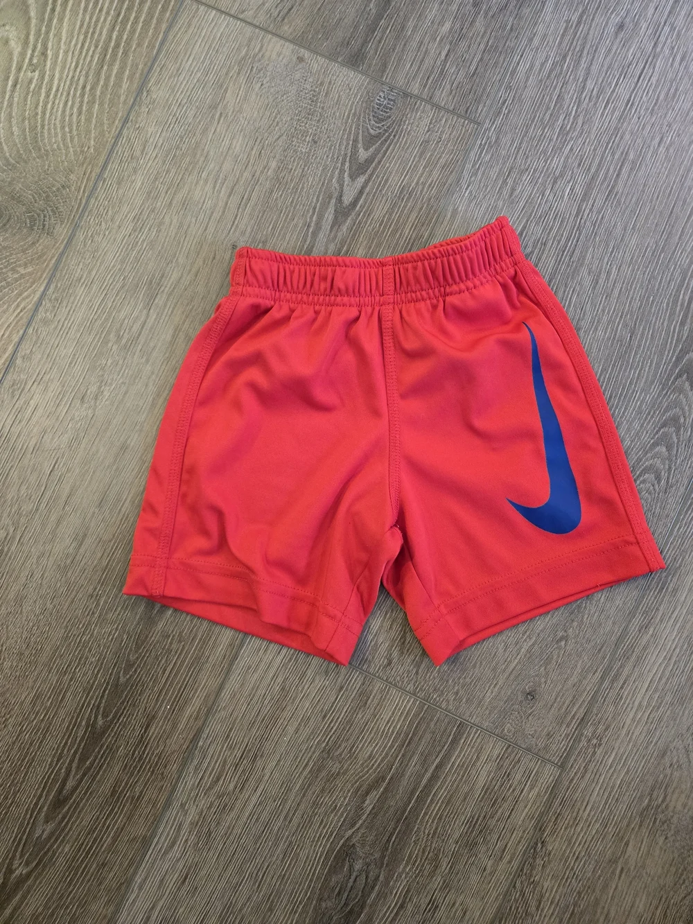 Nike Red Kids Athletic Shorts with Blue Swoosh Accent
